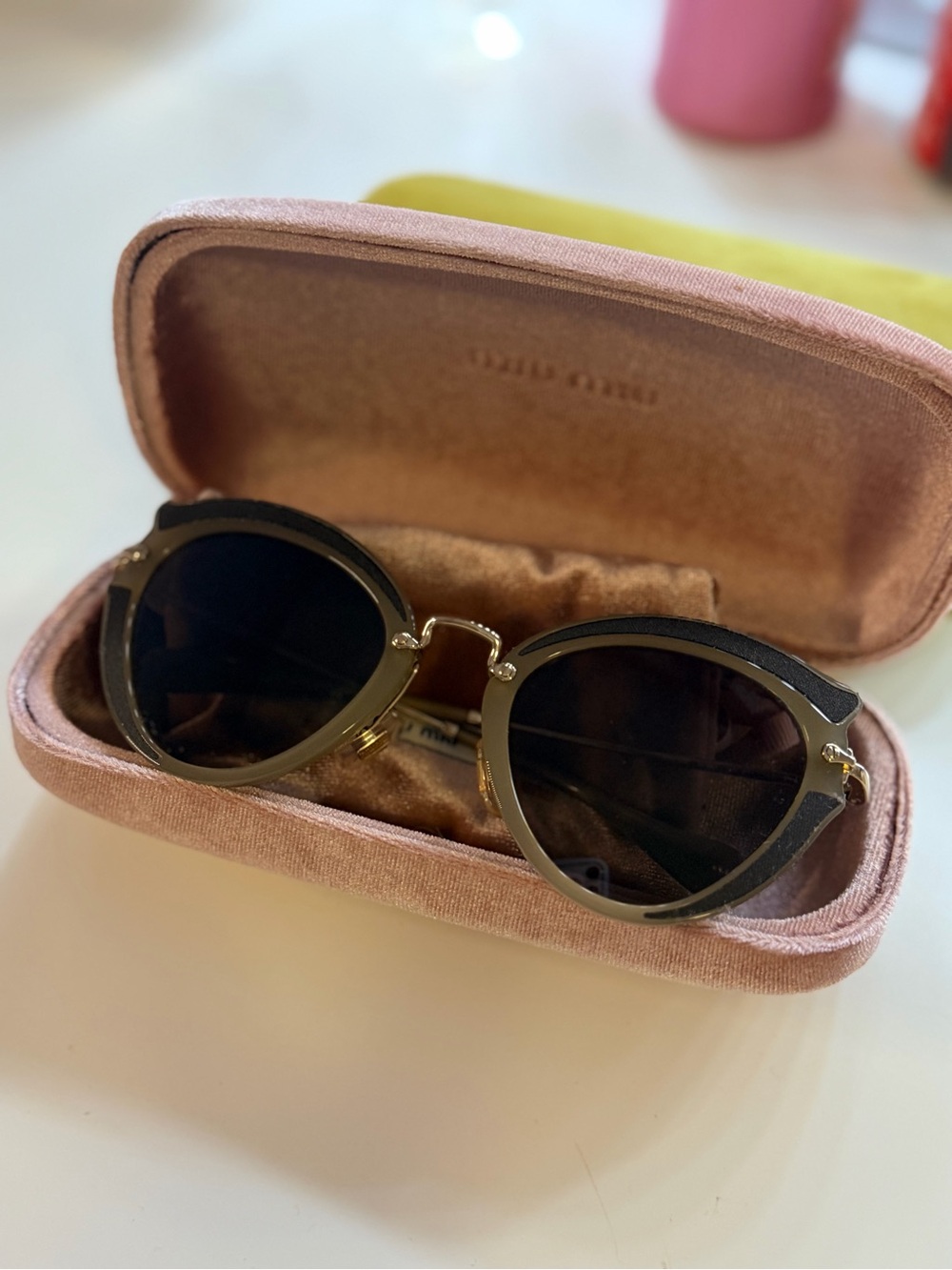 Miu Miu Black and Gold Round Sunglasses with Dark Lenses